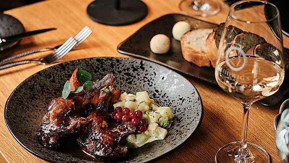 Hauptspeise mit Gans und leckerem Wein dazu im Restaurant Ludwigs